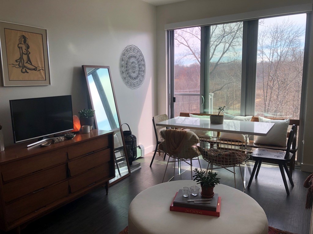 A living room with a white table and chairs.