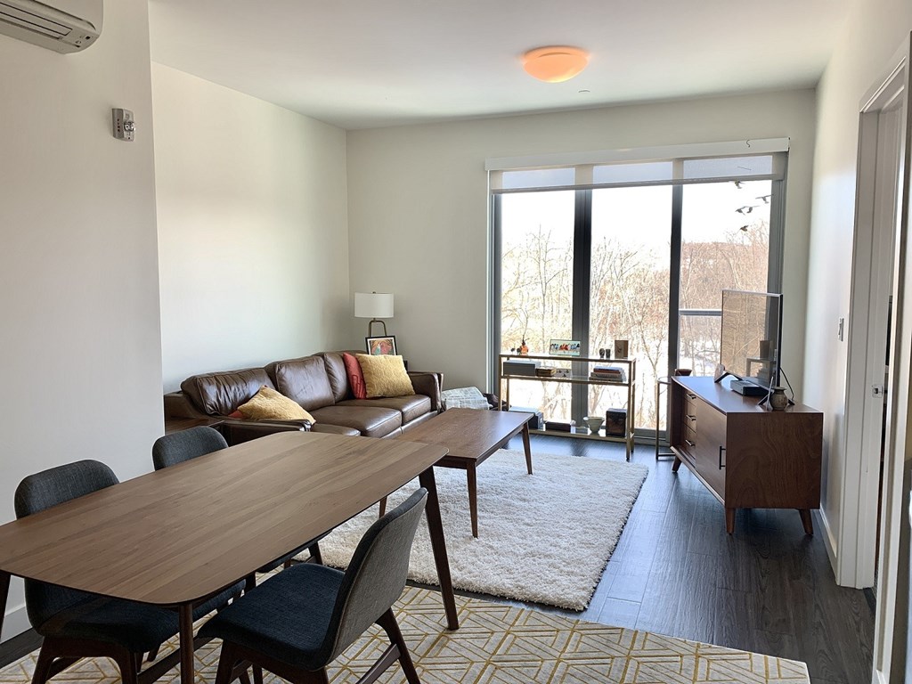 A living room with a brown table and chairs.