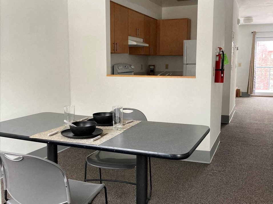 a kitchen and dining room with a table and chairs