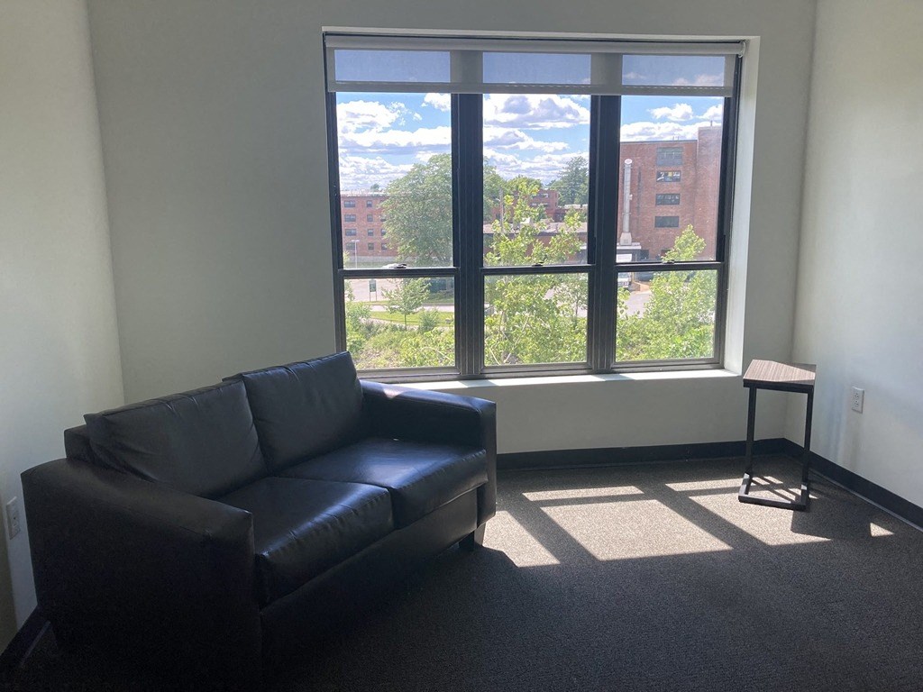 a living room with a couch and a window