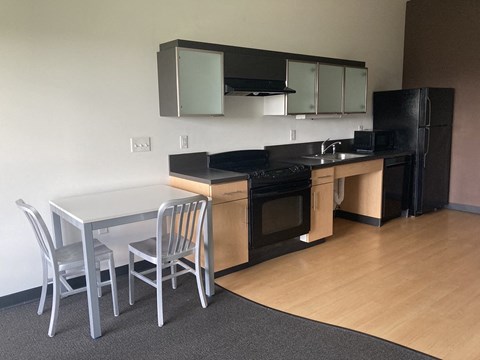a kitchen with a table and chairs and a kitchen
