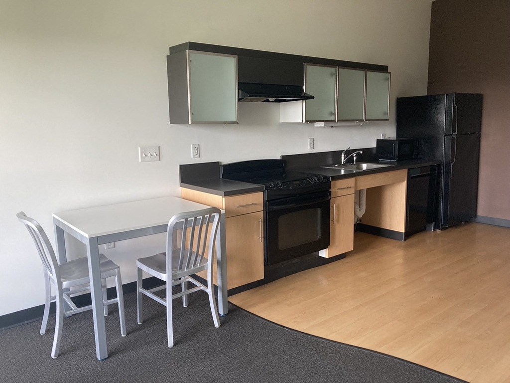 a kitchen with a table and chairs and a kitchen