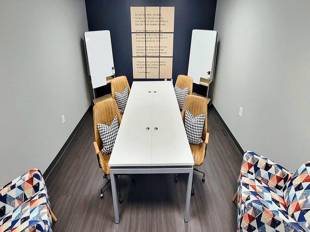 a conference room with a white table and chairs