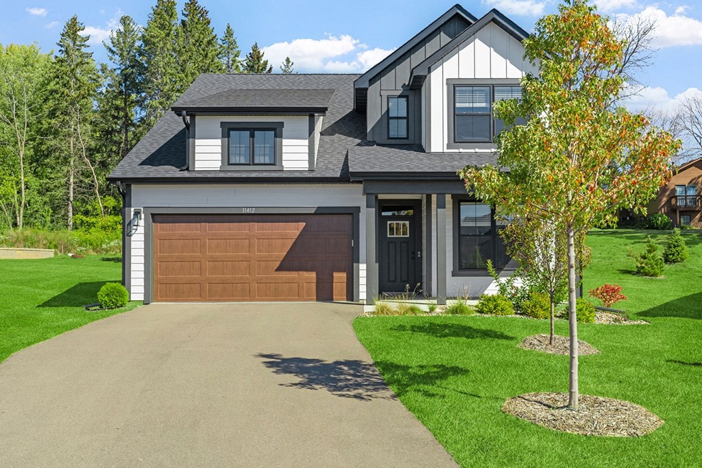 a house with a brown garage door and a driveway