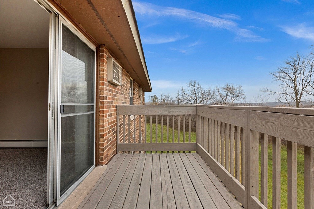 the deck of a home with a sliding glass door