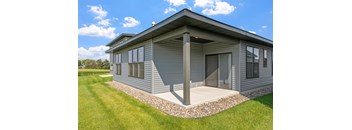 a small with a porch and a grassy yard