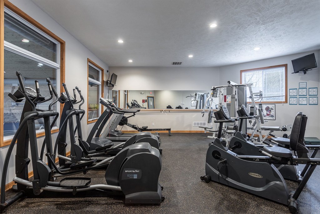 A gym with treadmills and exercise bikes.
