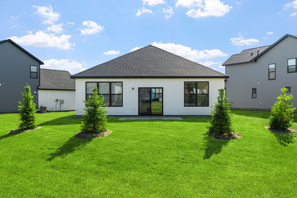 a white house with a yard in front of it