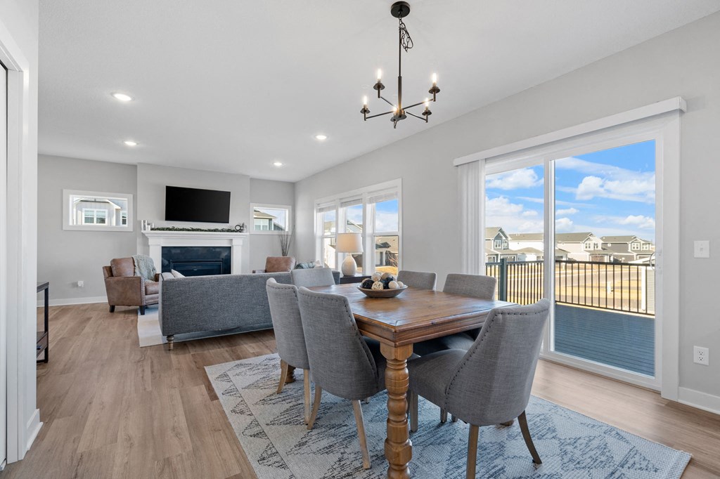 a living room with a table and chairs and a fireplace