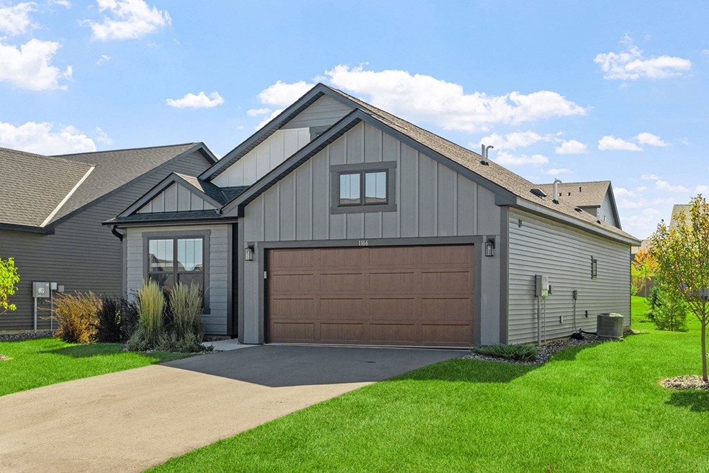 a house with a garage door and a driveway