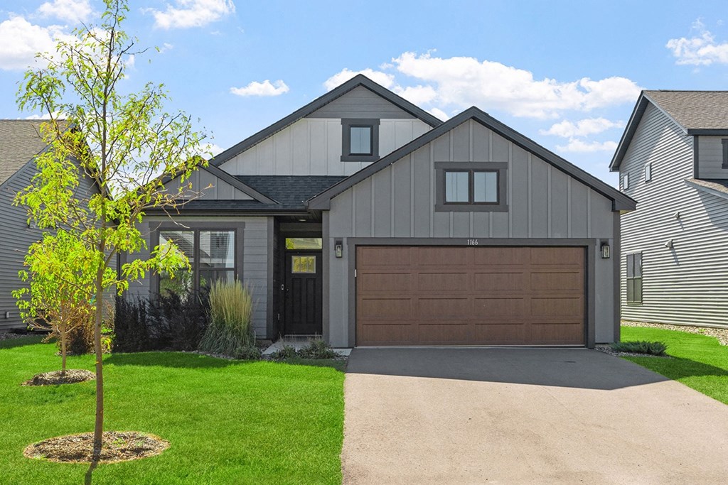 a house with a brown garage door and a driveway