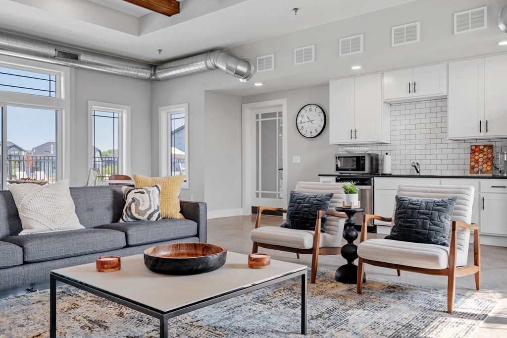 a living room with couches and chairs and a table