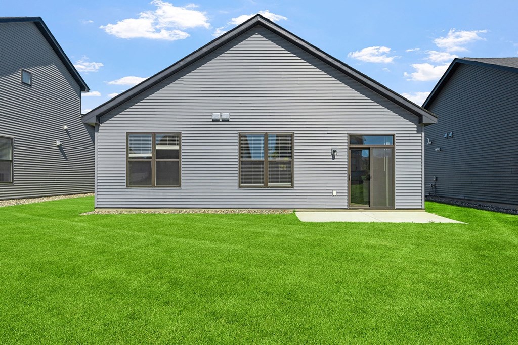a renovated house with a yard in front of it