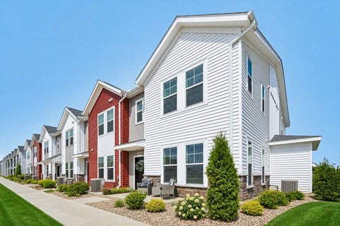 A row of houses with red and white exteriors.