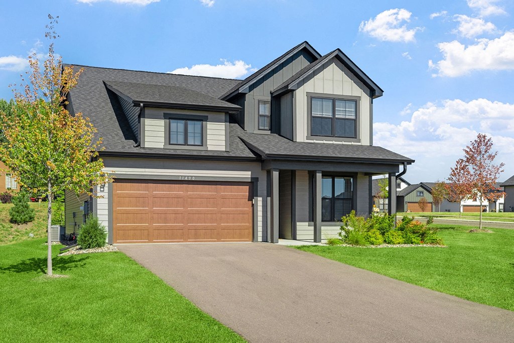 a house with a garage door and a driveway