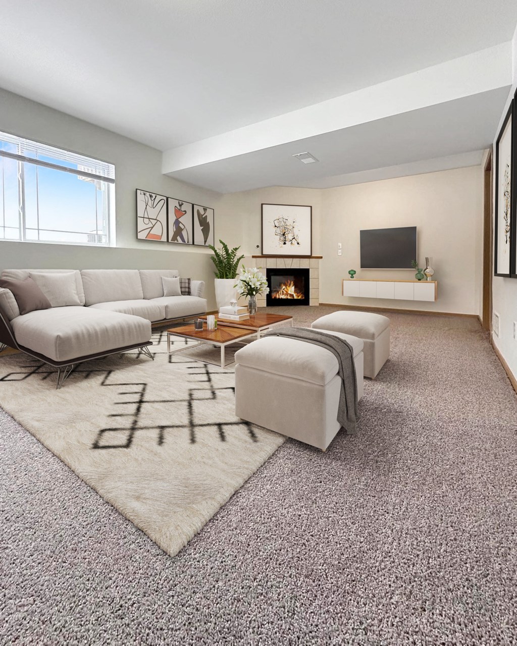A modern living room with a grey sofa, a fireplace, and a television.