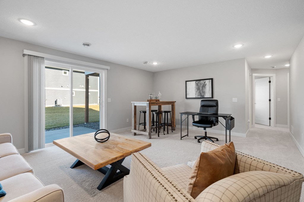 a living room with a couch and a chair and a table