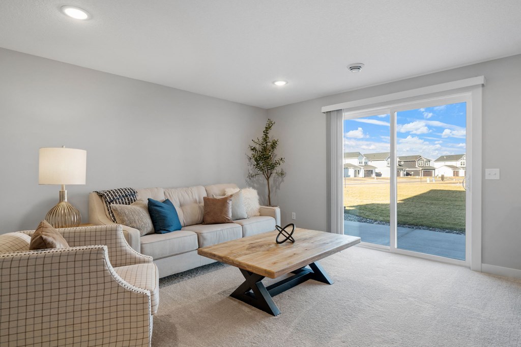a living room with a couch and a coffee table in front of a window