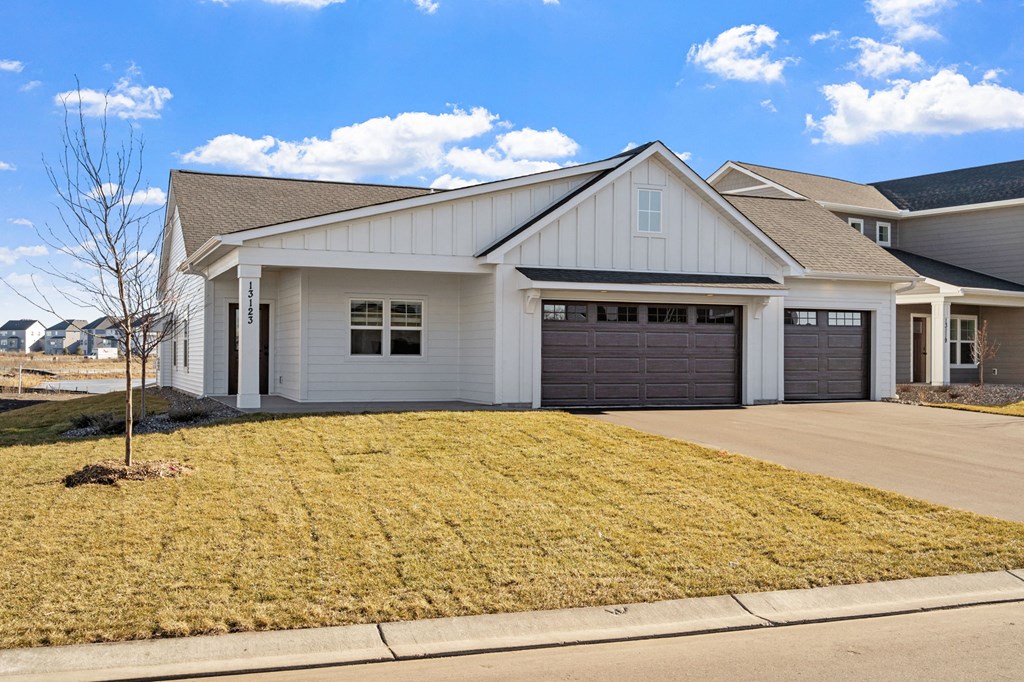 a white house with a driveway and a garage door