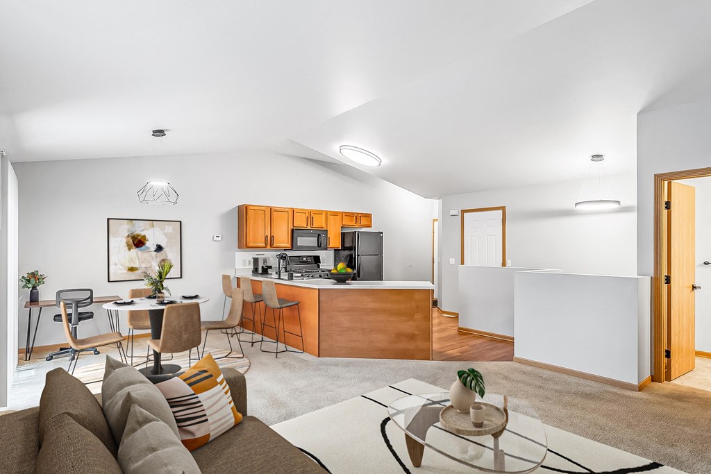 A modern living room with a brown sofa and a glass coffee table.