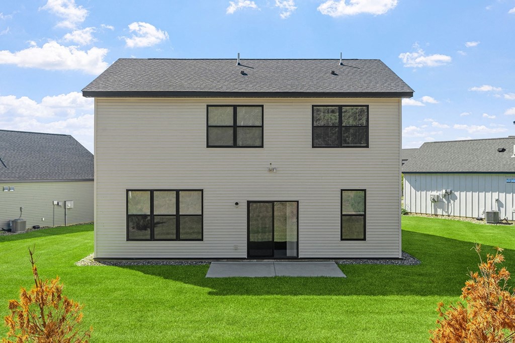 a white house with a lawn in front of it