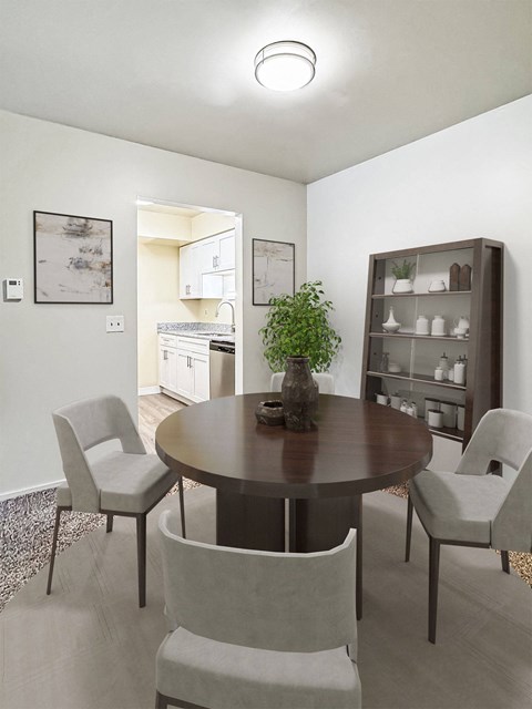 A dining room with a round table and chairs.