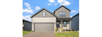 a house with a garage door in front of it