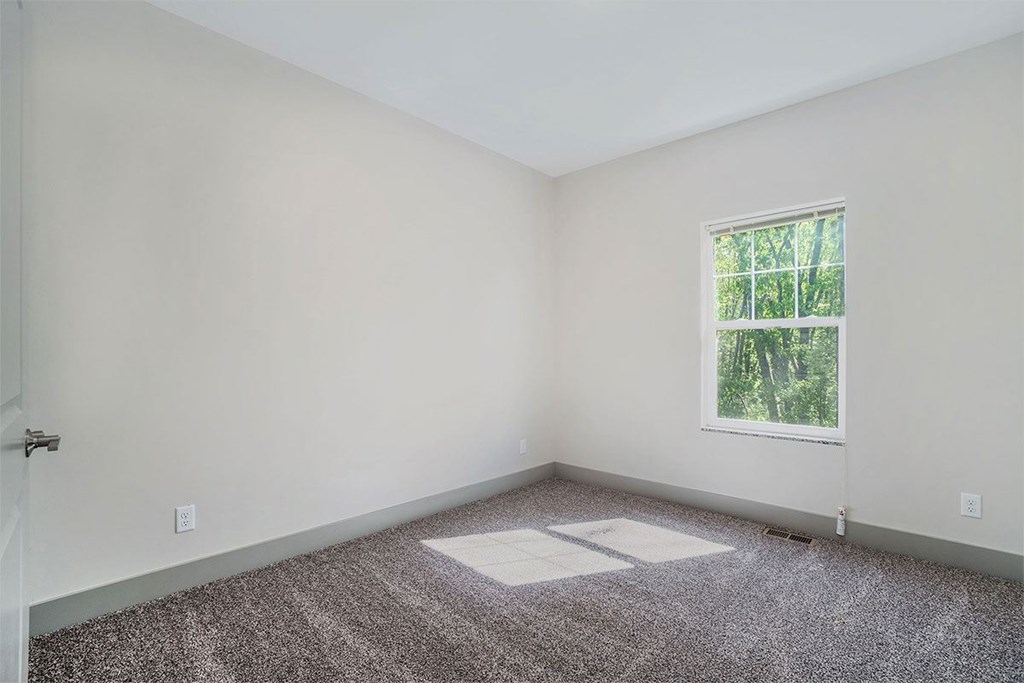 A room with a window and a door.