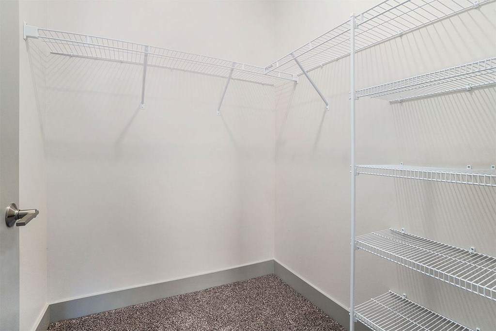 Empty white shelves in a room.