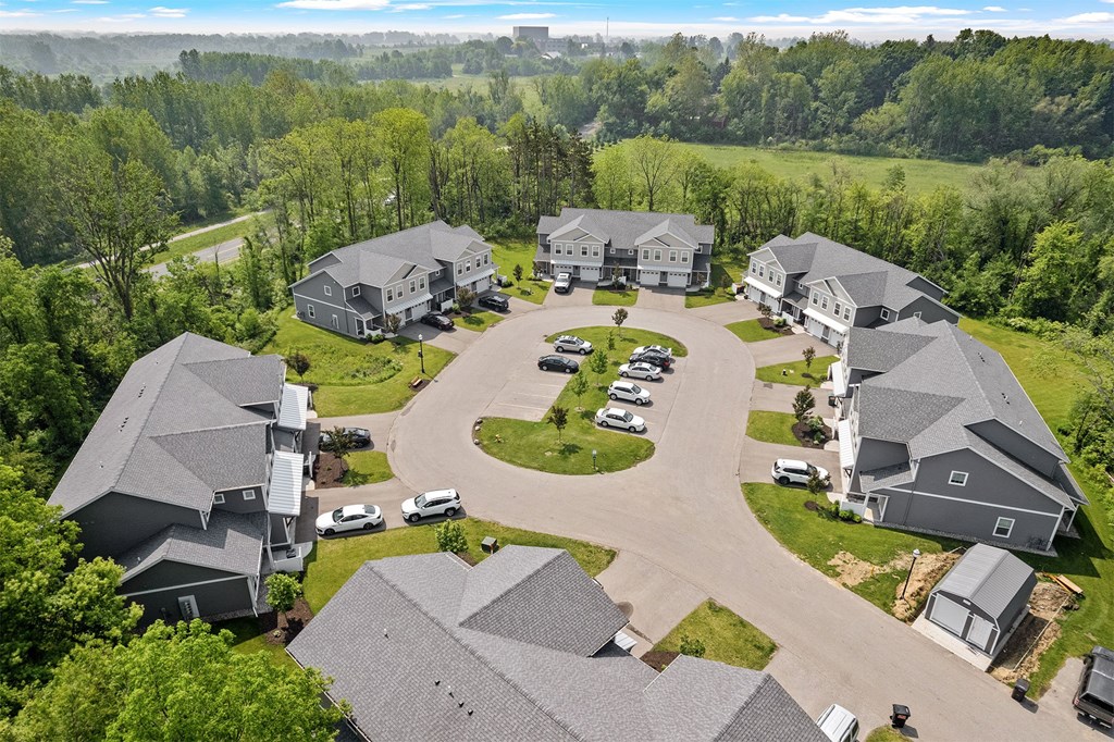 A bird's eye view of a residential area with houses and cars.