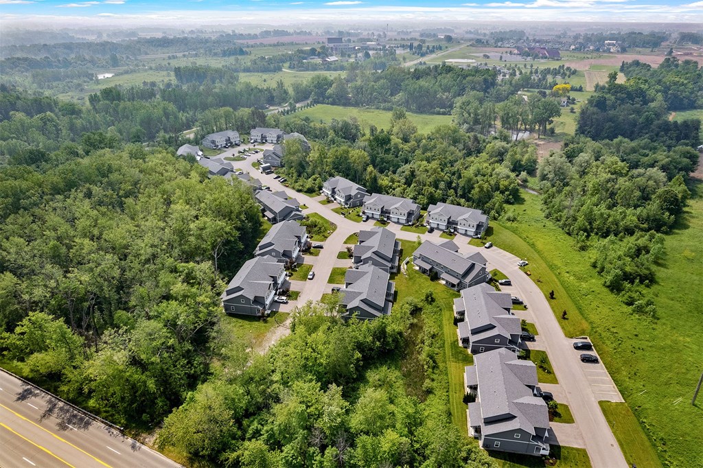 A bird's eye view of a residential area with houses and greenery.