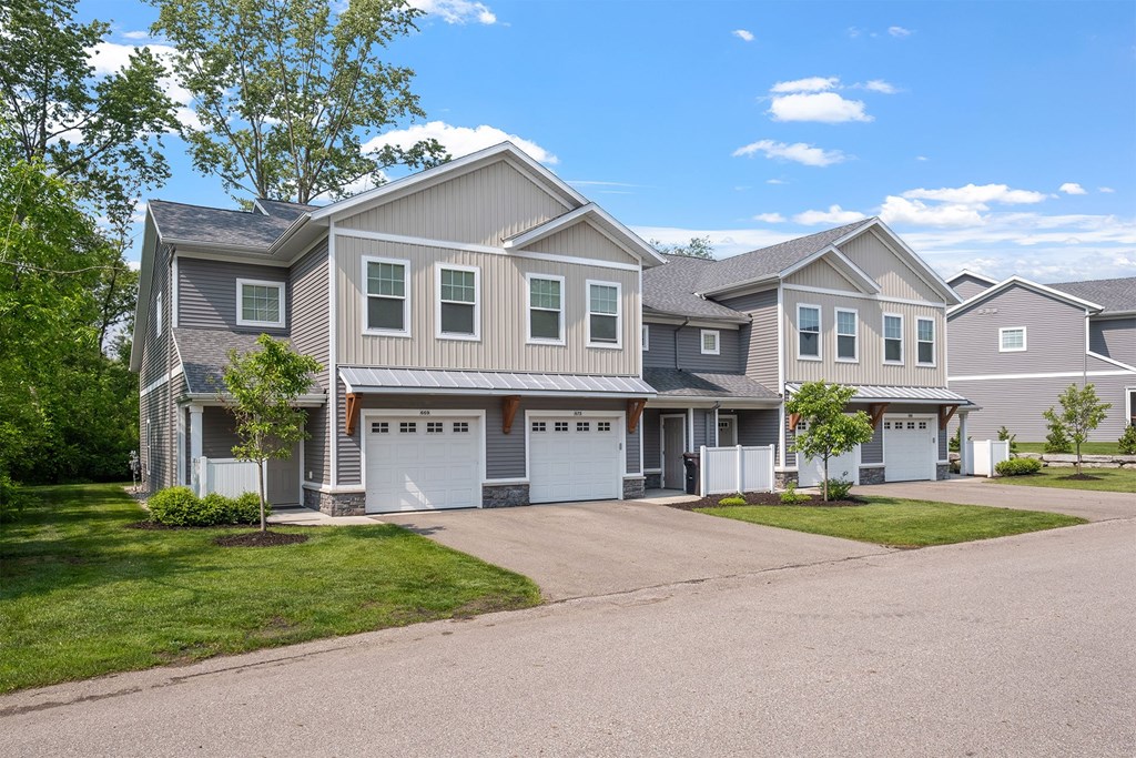 A row of houses with garages in front.