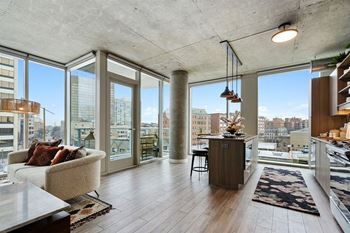a living room with a view of the city and a couch and a table