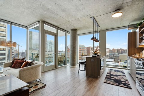 a living room with a view of the city and a couch and a table