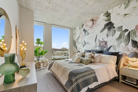 a bedroom with a bed and a large wall mural