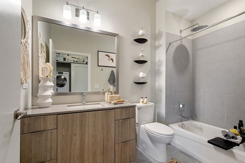 a bathroom with a toilet sink and a mirror