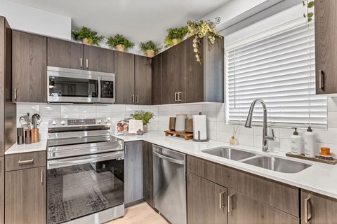 a kitchen with stainless steel appliances and wooden cabinets