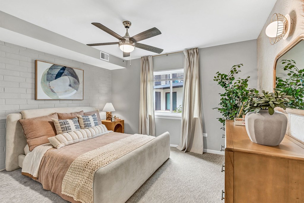 a bedroom with a bed and a ceiling fan