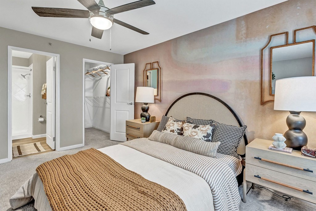 a bedroom with a bed and a ceiling fan