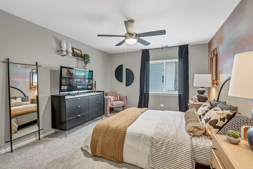 a bedroom with a large bed and a ceiling fan