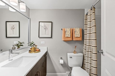 a bathroom with a toilet and a shower and a sink