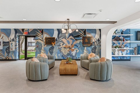 a lobby with chairs and a wall with a mural