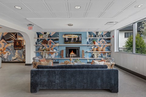 the lobby of a building with a couch and a fireplace