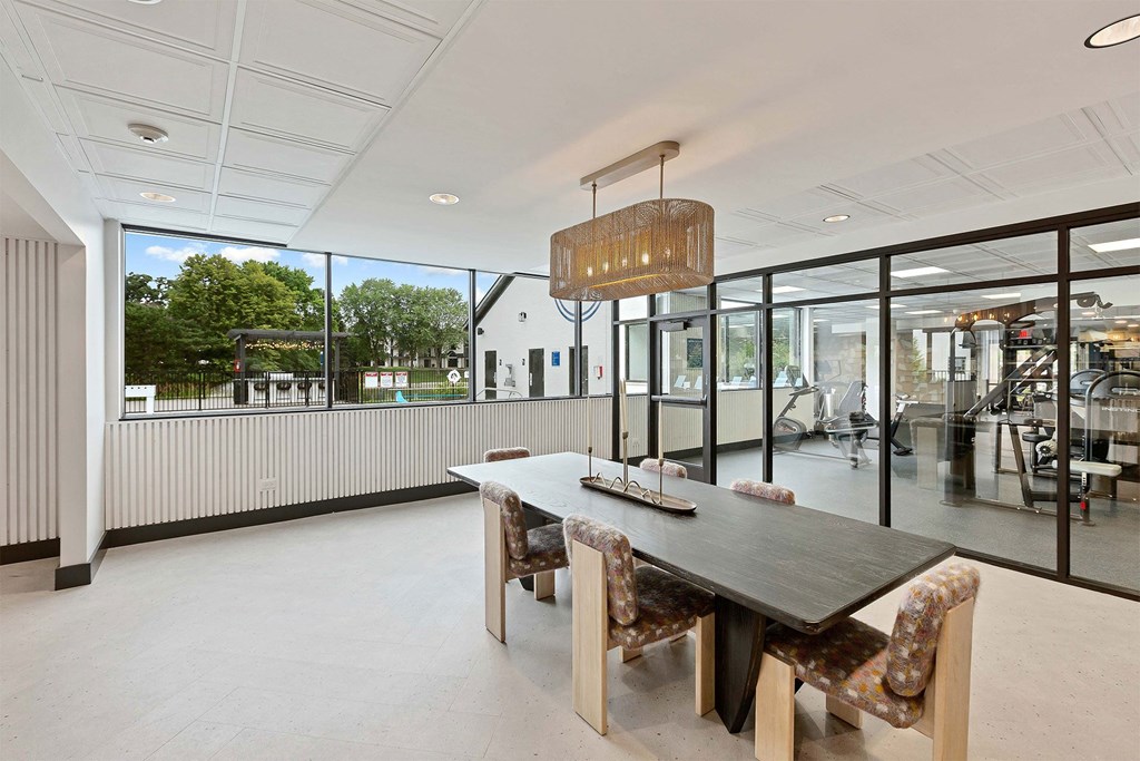 a dining room with a wooden table and chairs