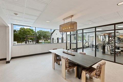 a dining room with a wooden table and chairs