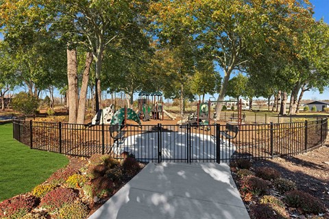 a view of a park with a playground and trees