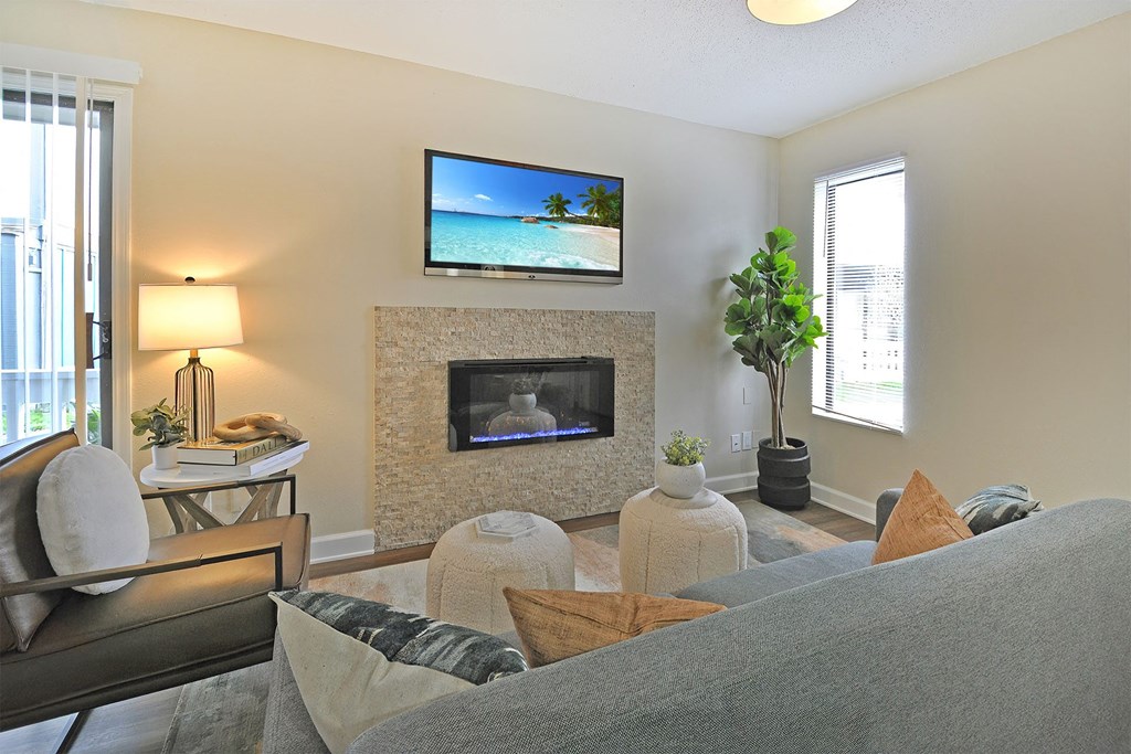 a living room with a fireplace and a tv above it