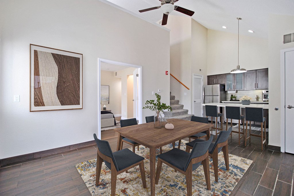 a dining room and living room with a table and chairs
