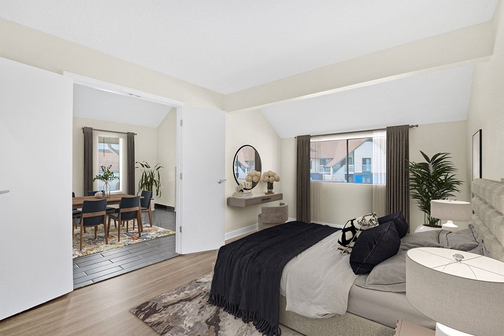 a bedroom with a bed and a living room with a dining room