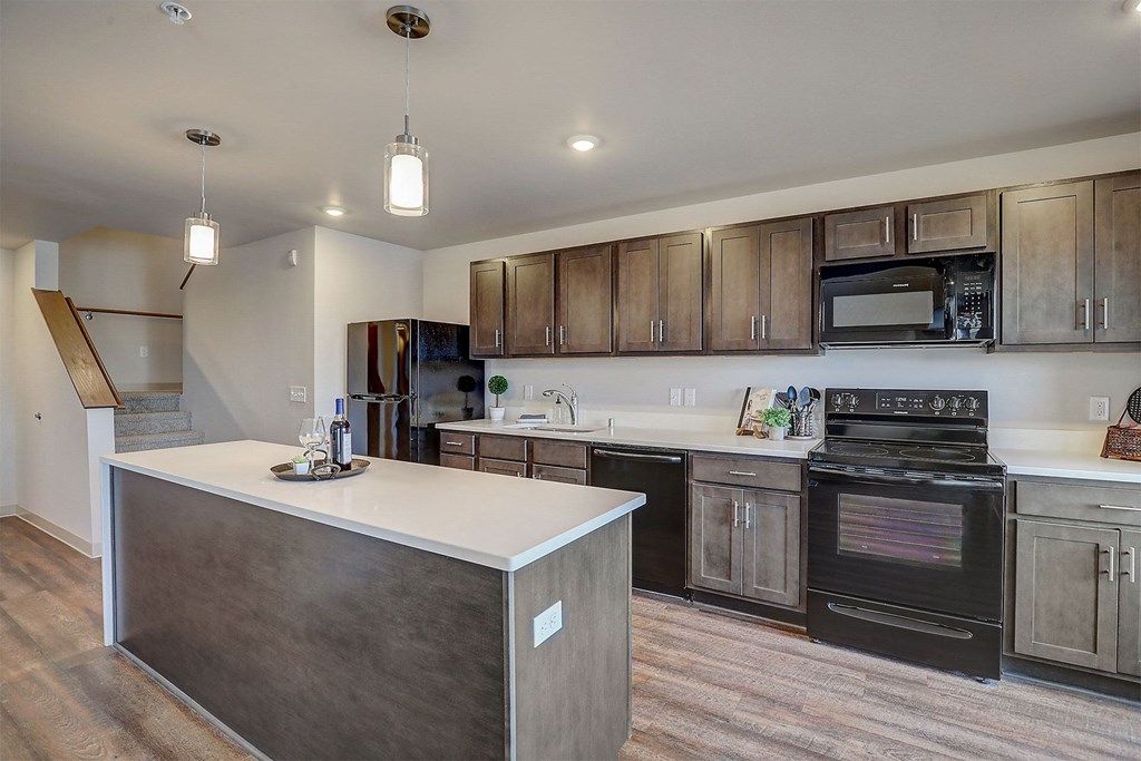 a kitchen with an island and a stove and a microwave